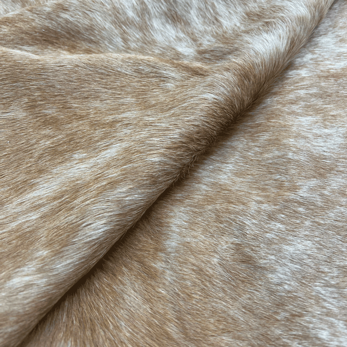 Plush golden tan cowhide rug